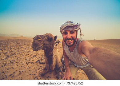 Happy Man Taking Crazy Selfie With Camel In Sahara Desert, Morocco