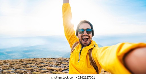 Happy man taking selfie on the top of the mountain - Millenial influencer on social media - Hiker on trekking excursion  - Shutterstock ID 2162127301