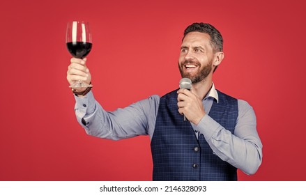 Happy Man Toastmaster Raise Glass Of Wine To Propose Toast Before Drinking Red Background, Cheers