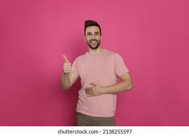 Happy Man Touching His Belly And Showing Thumb Up On Pink Background. Concept Of Healthy Stomach