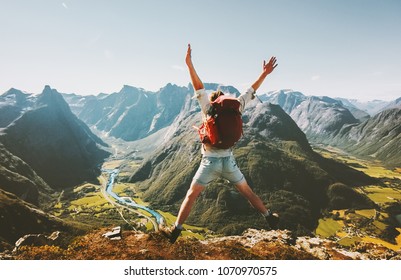 Happy Man traveler jumping with backpack Travel Lifestyle adventure concept active summer vacations outdoor in Norway mountains success and fun euphoria emotions  