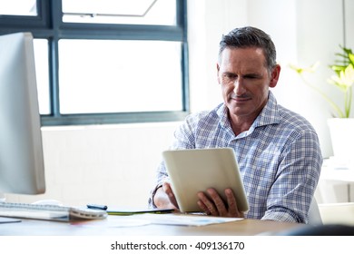 Happy man using digital tablet in office - Powered by Shutterstock - Get 15% off with code: PIKWIZARD15