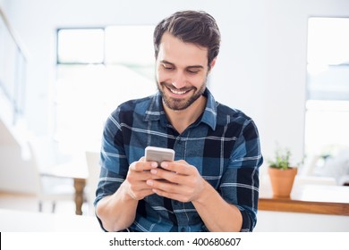 Happy man using mobile phone at home - Shutterstock ID 400680607