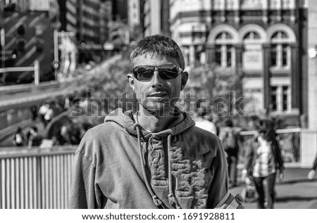 Similar – Man with sun hat and sunglasses on an old bridge