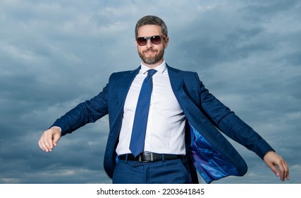 Happy Man Walking In Open Suit Jacket Fluttering In Wind Sky Background