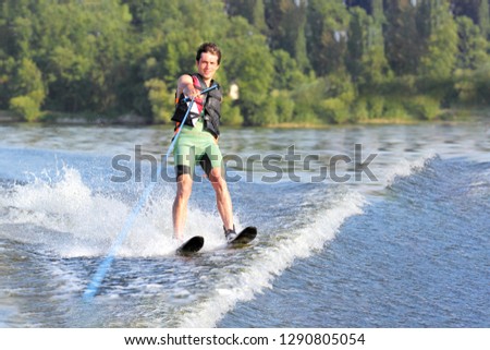 Happy man waterskiing and having fun. Living a healthy lifestyle and staying active. Doing water sports in the summer on a holiday. Copy space