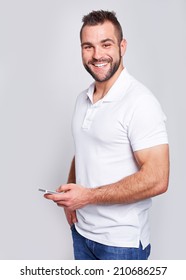 Happy Man In White Polo Shirt With Phone In Hand