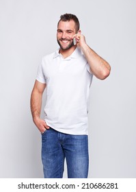 Happy Man In White Polo Shirt With Phone In Hand