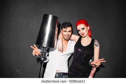 Happy Man In White Shirt Posing For Photo With Informal Girl On Gray Background. Redhead Woman Photographing With Stranger At Party.