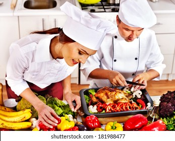 Happy Man And Woman In Chef Hat Cooking Chicken.