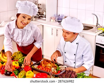 Happy Man And Woman In Chef Hat Cooking Chicken.