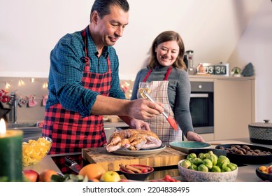 Happy Man And Woman Cooking Together Traditional Dinner For Christmas At Home Kitchen