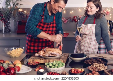 Happy Man And Woman Cooking Together Traditional Dinner For Christmas At Home Kitchen