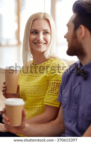 happy man and woman drinking coffee in office
