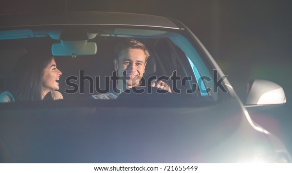 The happy man and woman drive a vehicle. evening\
night time