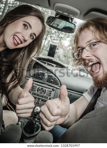 Happy man and woman\
during traveling trip. Couple, friends sitting inside vehicle car\
driving riding somewhere.