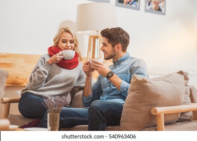 Happy Man And Woman Enjoying Hot Drink