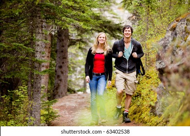 A Happy Man And Woman Hiking On A Camping Trip