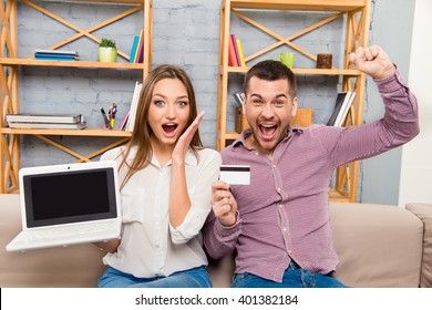 Happy man and woman screaming with laptop and bank card