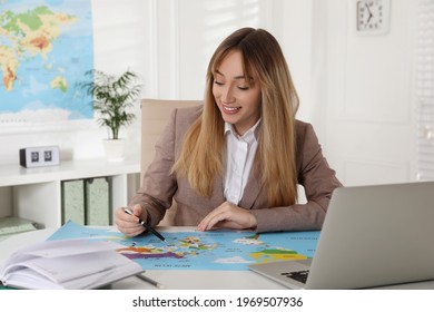 Happy manager working at desk in travel agency - Powered by Shutterstock