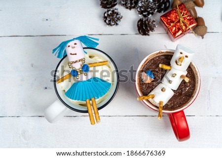 Happy marshmallow man inside a cup of coffee at christmas 