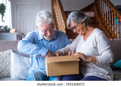 Happy Mature Aged Older Family Couple Unpacking Carton Box, Satisfied With Internet Store Purchase Or Unexpected Gift, Feeling Excited Of Fast Delivery Shipping Service, Positive Shopping Experience.