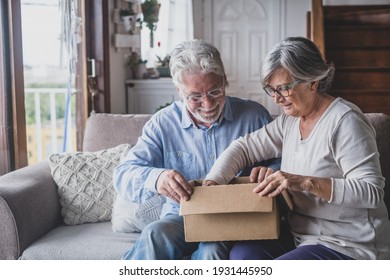 Happy Mature Aged Older Family Couple Unpacking Carton Box, Satisfied With Internet Store Purchase Or Unexpected Gift, Feeling Excited Of Fast Delivery Shipping Service, Positive Shopping Experience.