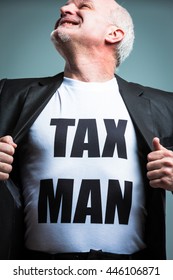 Happy Mature Bearded Man Looking Upward In Heroic Pose While Opening Suit Jacket With Tax Man Text In Large Letters On Torso.