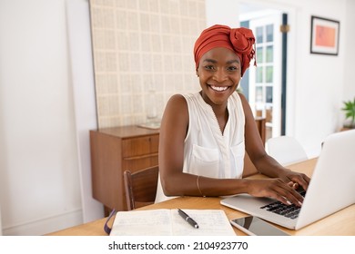 Happy Mature Black Businesswoman Working On Laptop At Home During Lockdown Or Quarantine. Successful Middle Aged African Woman Using Computer While Looking At Camera: Telecommuting And Smart Working.