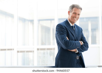 Happy Mature Business Man Looking At Camera With Satisfaction At Office