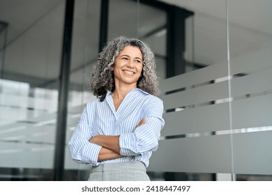 Happy mature business woman leader standing in office looking away. Smiling confident older middle aged professional lady corporate leader, senior female executive or entrepreneur portrait. - Powered by Shutterstock