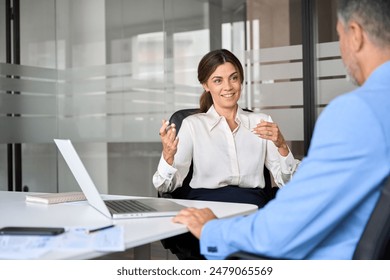 Happy mature business woman professional bank manager or financial advisor consulting client. Two older executives team business people man and woman working at office corporate meeting. - Powered by Shutterstock