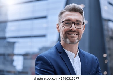 Happy, mature businessman and face for confidence in professional career as leader outdoors in urban city. Smile, male person or ceo with glasses for pride, ambition and growth in job outside office - Powered by Shutterstock