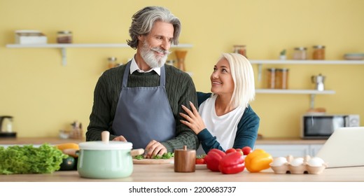 Happy Mature Couple Cooking Dinner At Home