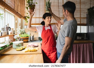 Happy Mature Couple Cooking Together At Home Having Fun - Preparing Healthy Lunch In Modern Kitchen - Lifestyle Family Time And Food Nutrition Concept