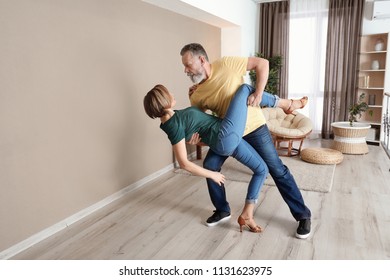 Happy Mature Couple Dancing At Home