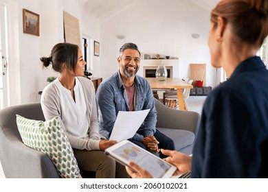 Happy mature couple discussing investments with financial broker during meeting at home. Middle eastern man and woman discussing about financial planning with consultant at home. Financial consultant  - Shutterstock ID 2060102021