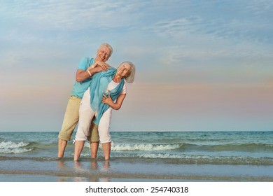 Happy Mature couple enjoy fresh air on beach