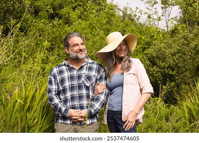 Happy mature couple enjoying nature walk in lush green garden together, outdoors. happiness, walking, gardening, outdoors, relationship, foliage - Powered by Shutterstock