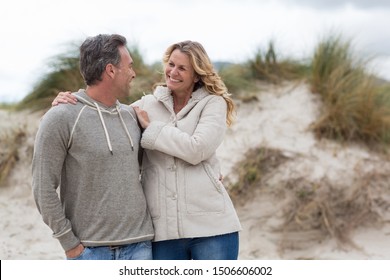 Happy mature couple enjoying on the beach - Powered by Shutterstock