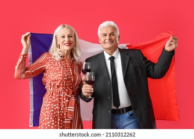 Happy Mature Couple With Flag Of France On Color Background