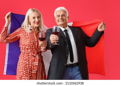 Happy Mature Couple With Flag Of France On Color Background