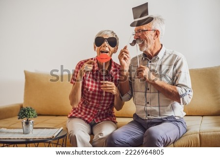 Happy mature couple is having fun at home.