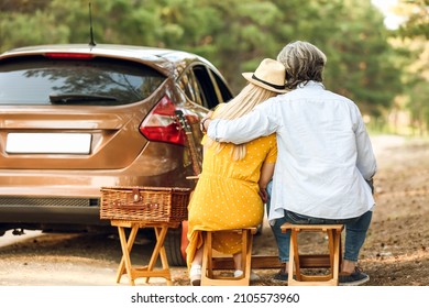 Happy Mature Couple Hugging Near Car Outdoors