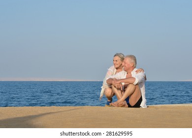 Happy Mature couple on beach near sea