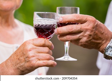 Happy Mature Couple - Senior People (man And Woman) - Drinking Wine