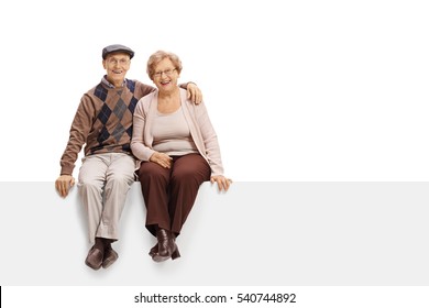 Happy mature couple sitting on a panel isolated on white background - Powered by Shutterstock