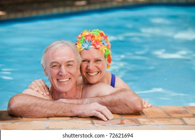 Happy Mature Couple In The Swimming Pool