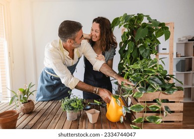 happy mature couple watering plants at home gardening - Powered by Shutterstock