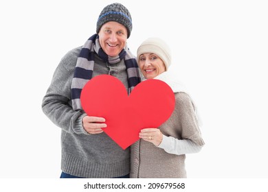 Happy Mature Couple In Winter Clothes Holding Red Heart On White Background